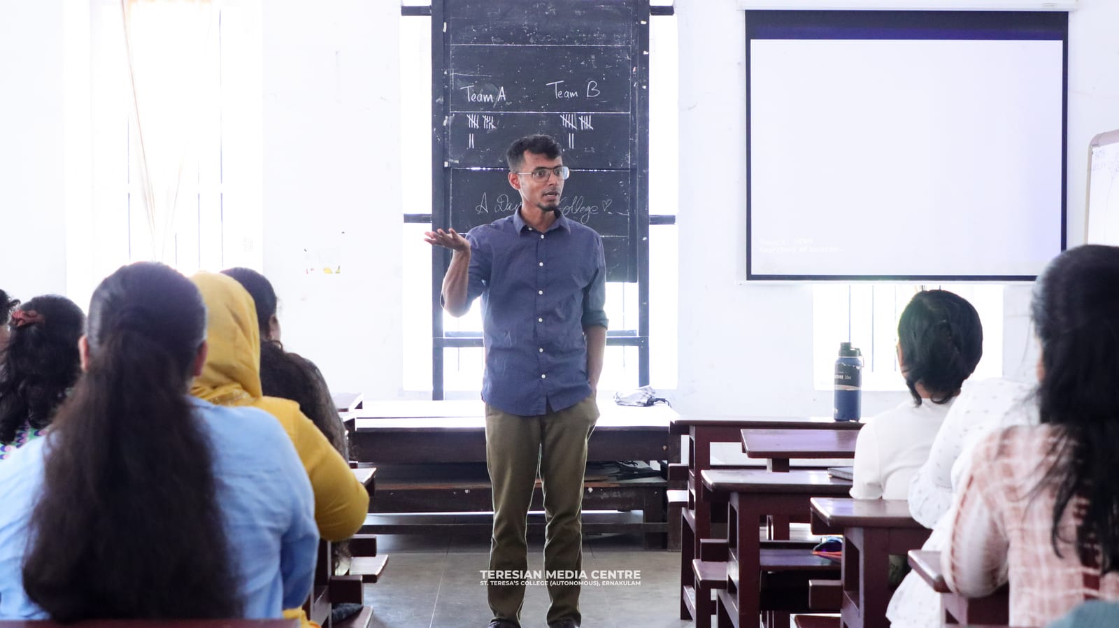An NPoC facilitator teaching a classroom of students