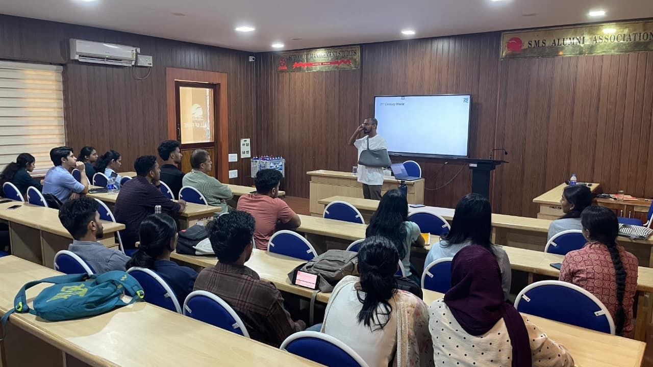 A facilitator presenting to a room of students and professionals