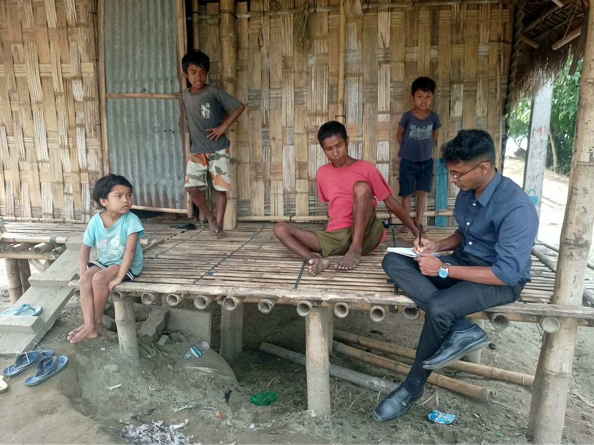 An NPoC researcher interviewing a family on their porch