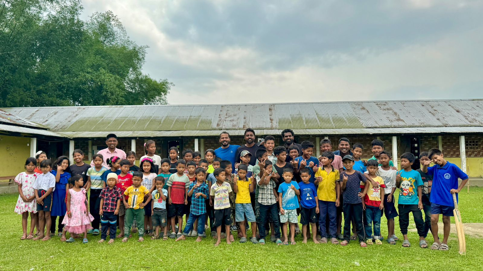Children and community members gathered outside a community hall