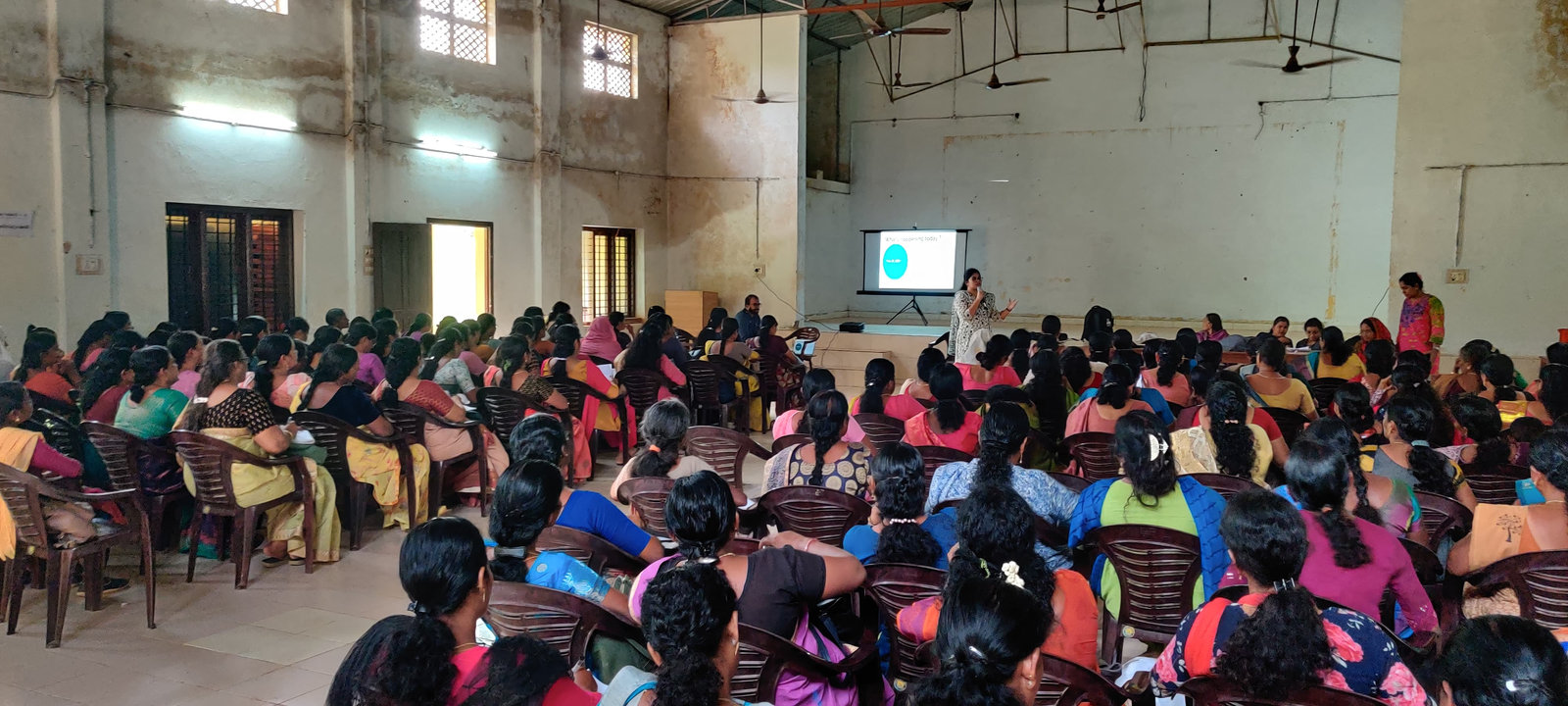 Teachers listen to a presentation during the training