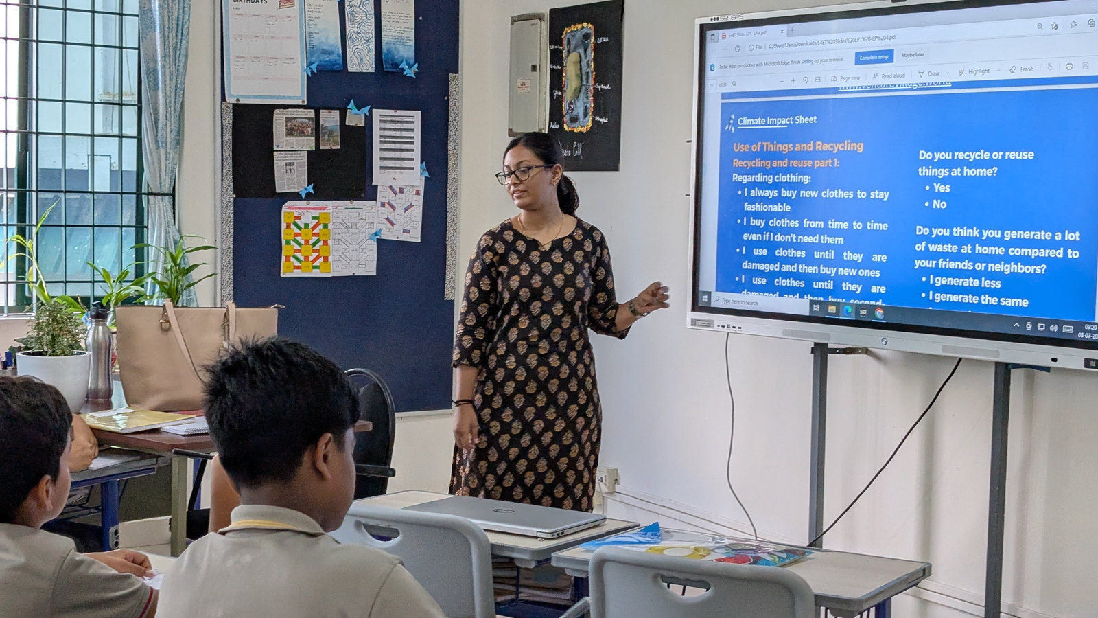 A facilitator presents on a screen during a training session