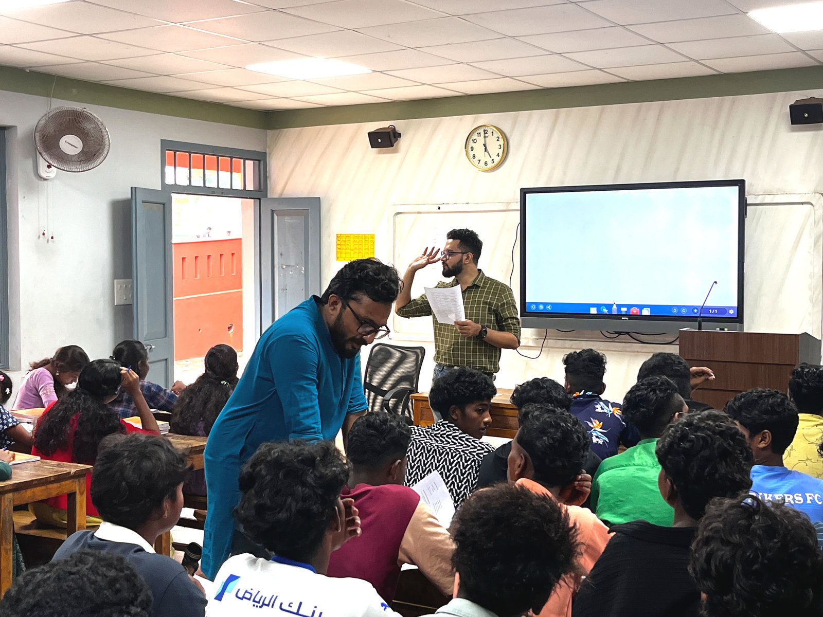 An NPoC team member speaks to a class at the Model Residential School